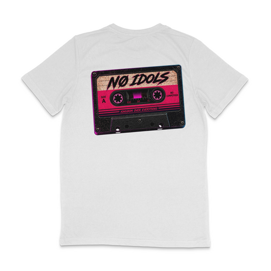 A white short-sleeve t-shirt shown from the back, featuring a large graphic print of a retro cassette tape with pink, purple, and black details and the text 'NO IDOLS' and 'ANTIFASCIST FILM FESTIVAL'.