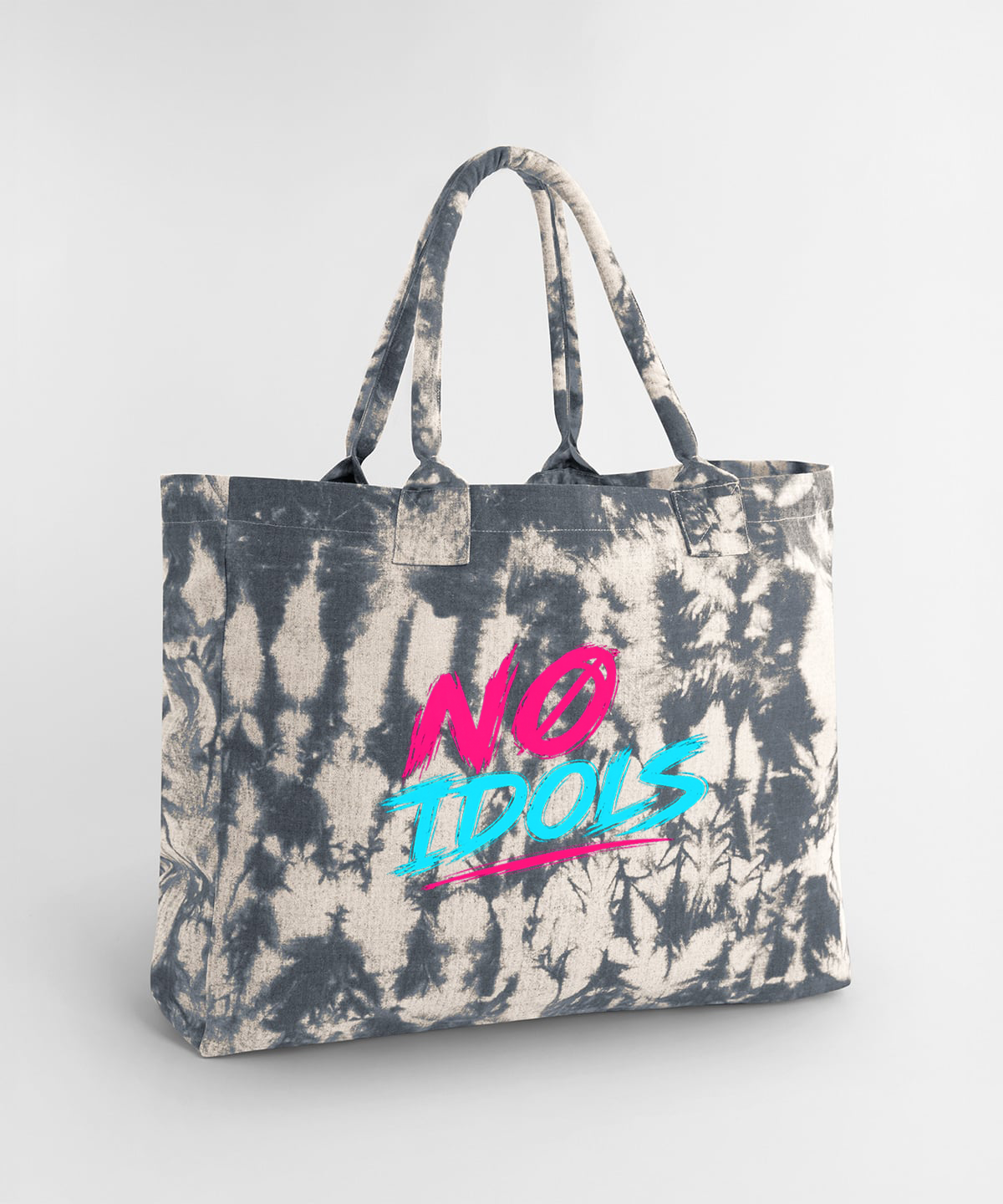 A canvas tote bag with a gray and off-white tie-dye pattern, featuring the text 'NO IDOLS' printed on the front in vibrant pink and blue.