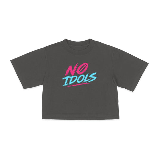 A dark gray toddler crop top t-shirt featuring a colorful graphic print on the chest that reads 'NO IDOLS' in pink and light blue stylized lettering, displayed against a solid white background.