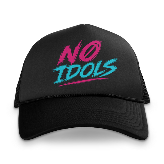 A black trucker hat with a curved brim and black mesh back, featuring a vibrant graphic on the front that reads 'NO IDOLS' in pink and teal brush-stroke lettering, set against a plain white background.
