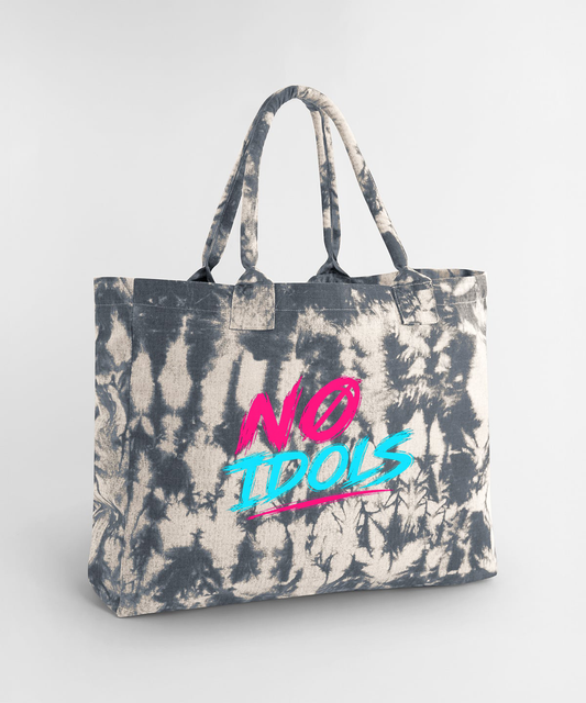 A canvas tote bag with a gray and off-white tie-dye pattern, featuring the text 'NO IDOLS' printed on the front in vibrant pink and blue.